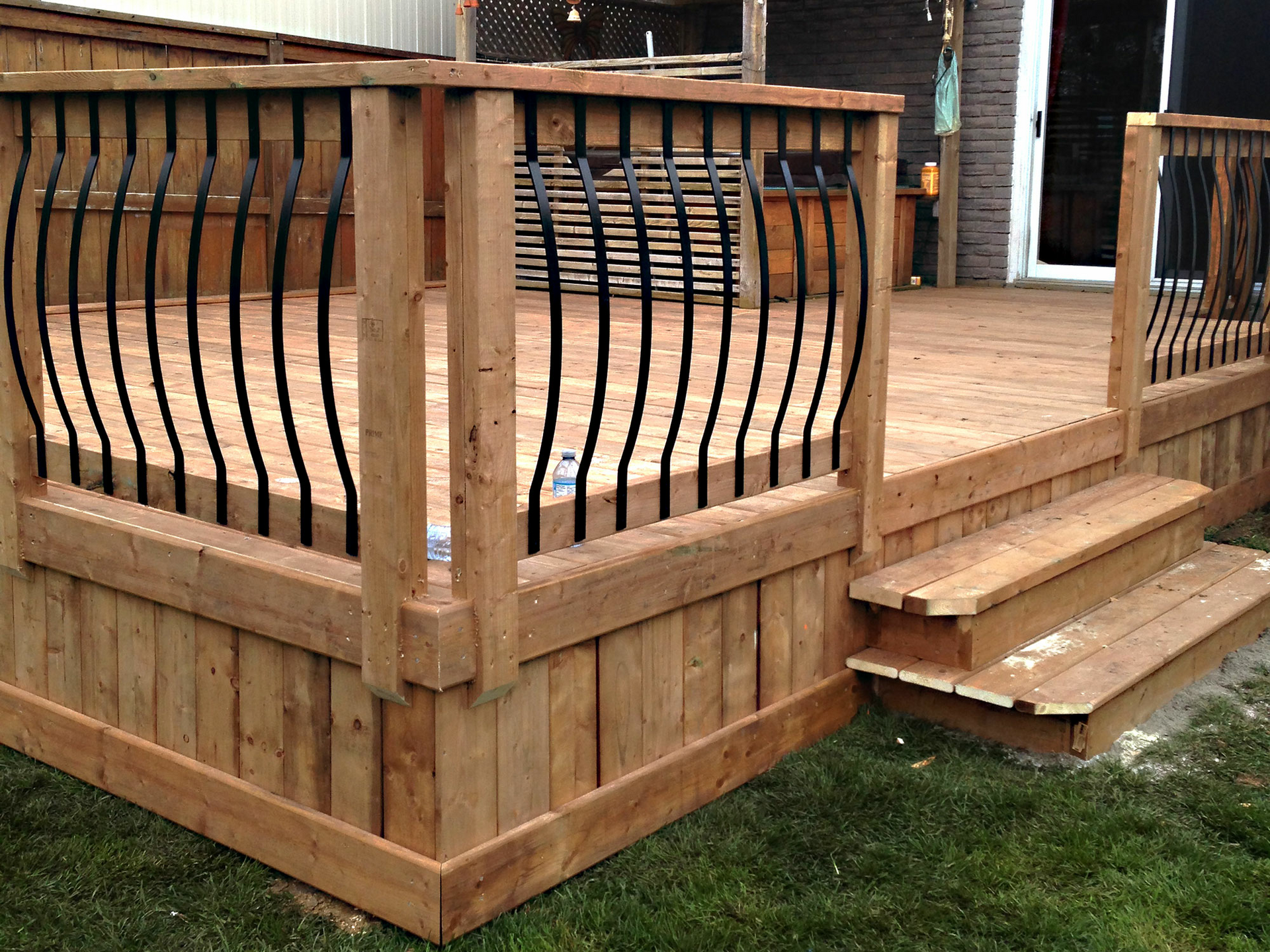 Curved balusters with pressure treated deck